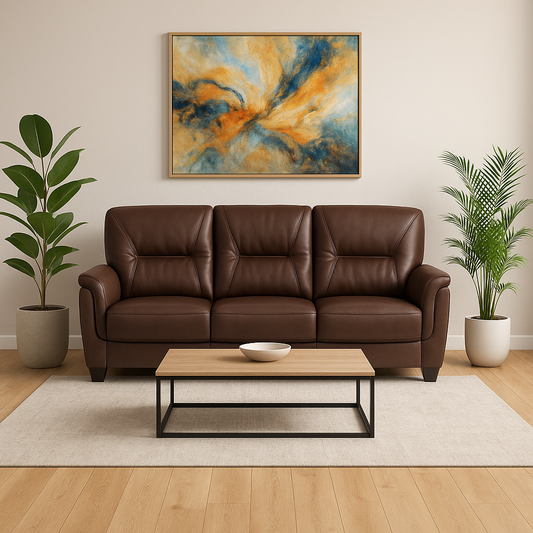 Brown leather sofa in a living room with a abstract painting, coffee table, and plants.